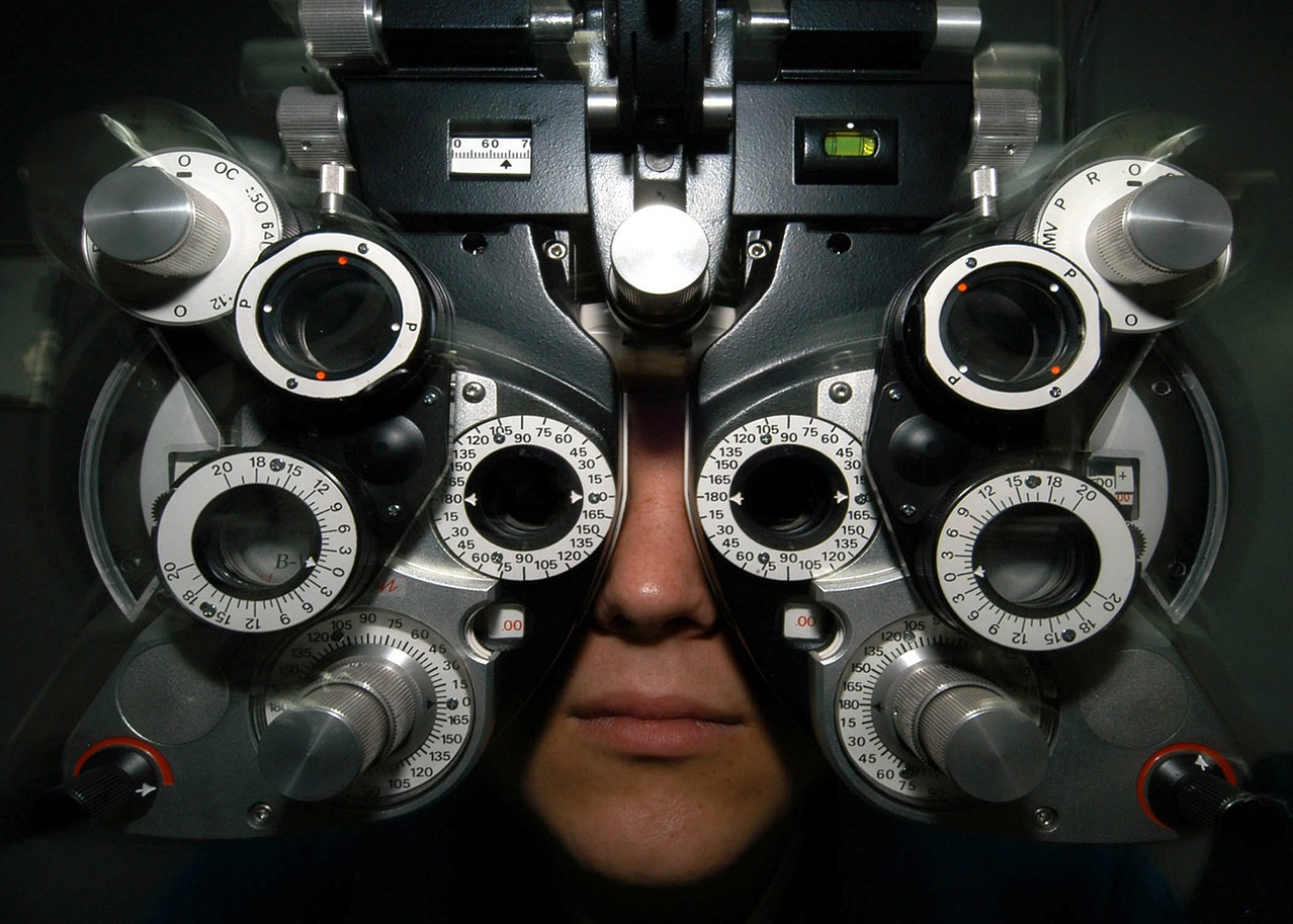 Person looks through eye measuring equipment